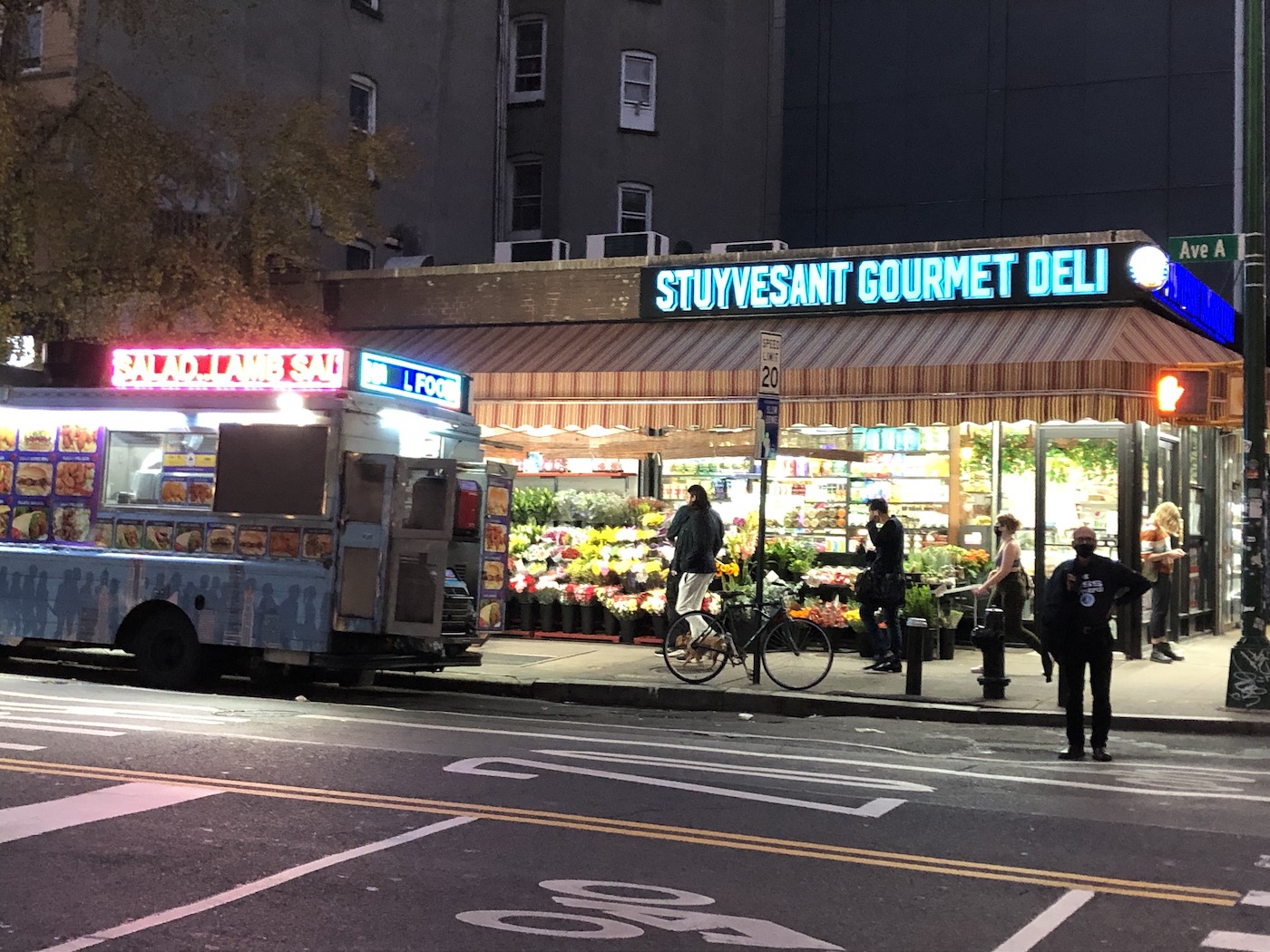 A picture of the outside of a small deli in New York.