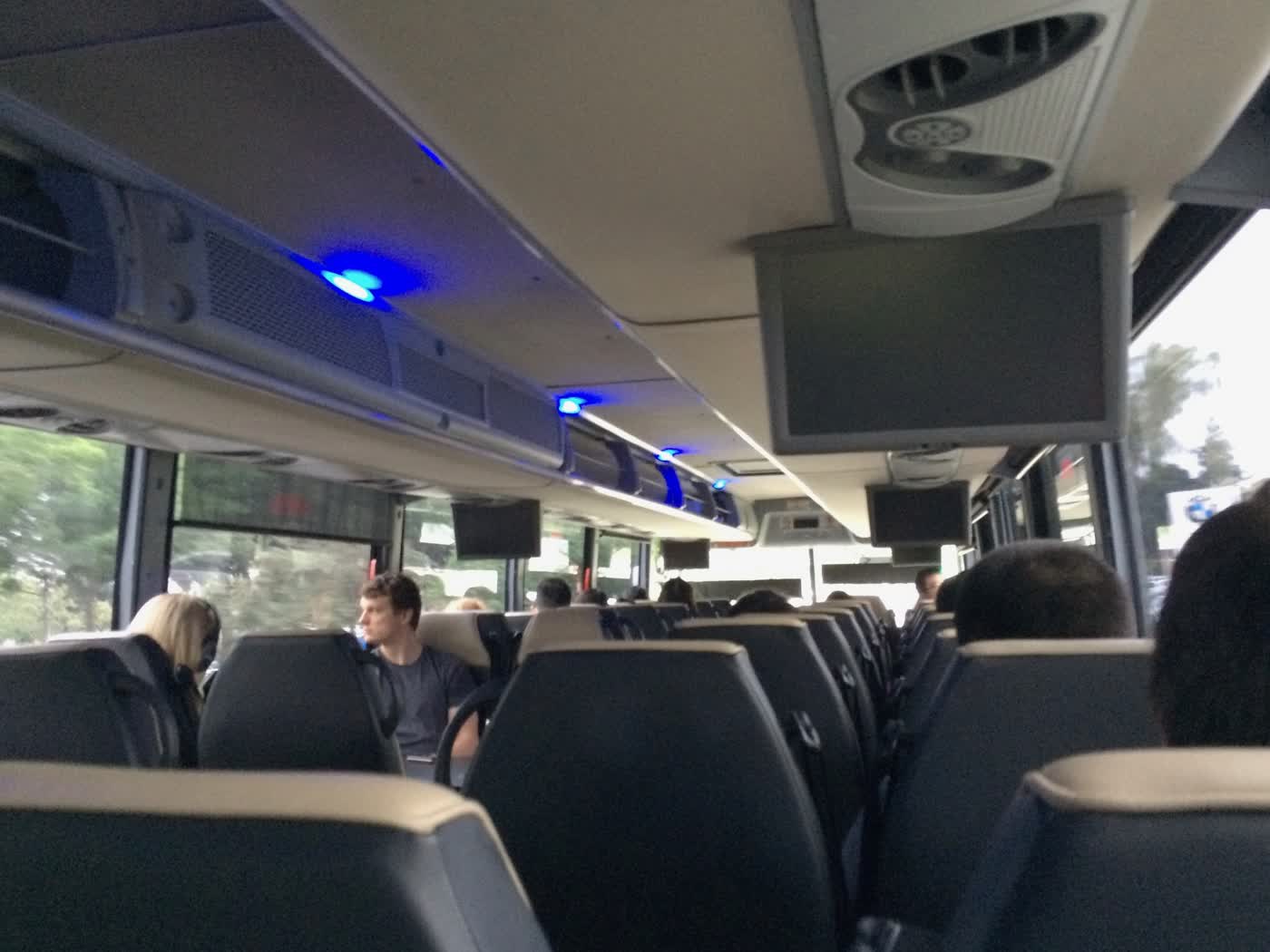 The interior of a charter-style bus, taken from one of the seats.