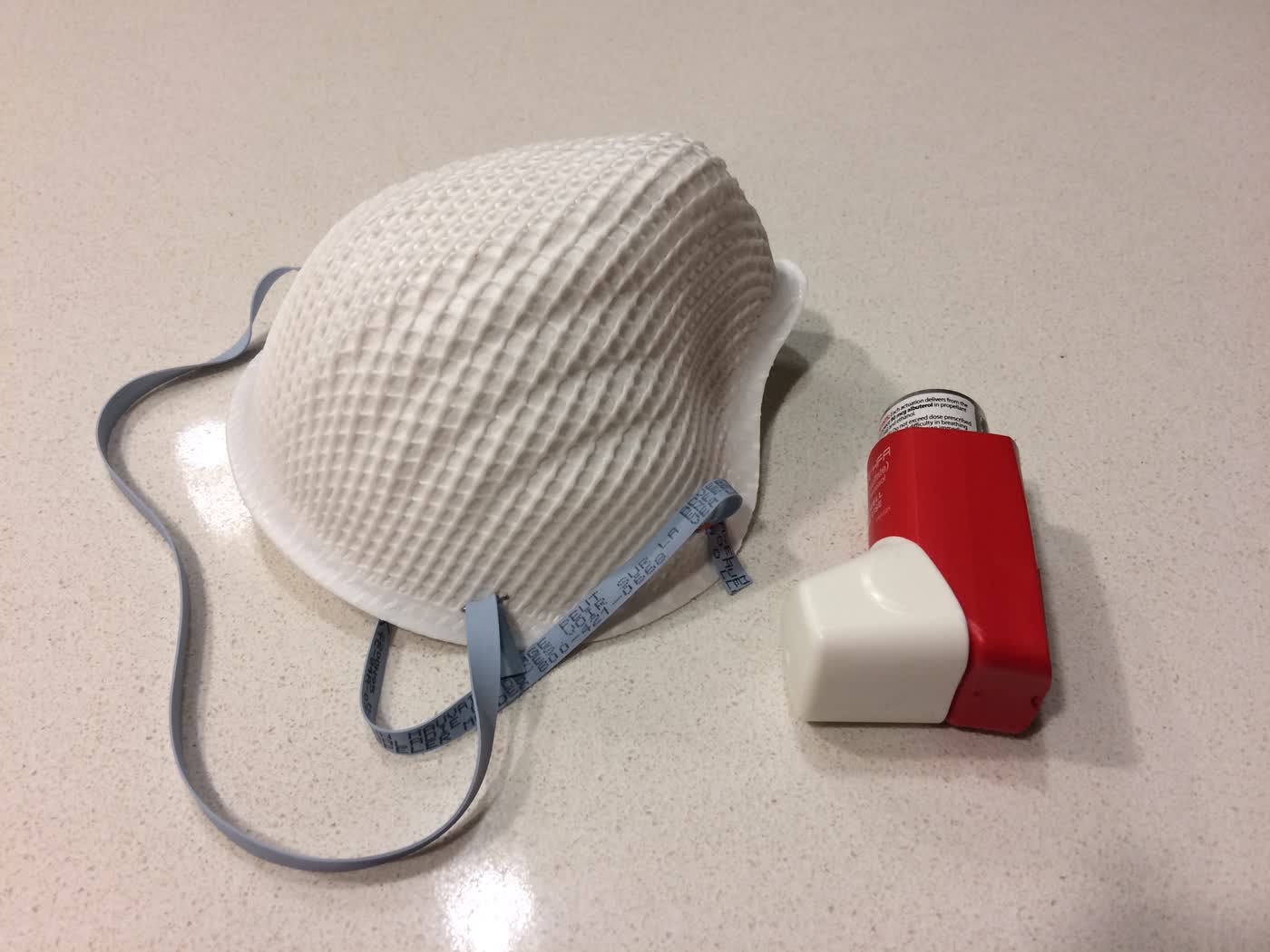 An N95 respirator and an asthma inhaler.