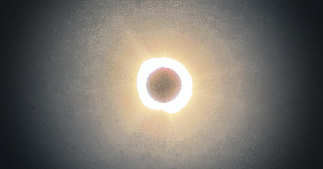 A vignetted banner image showing a grainy close-up of the sun at totality.